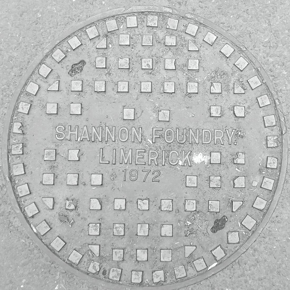 A round cast-iron cover stamped by the Shannon Foundry, Limerick